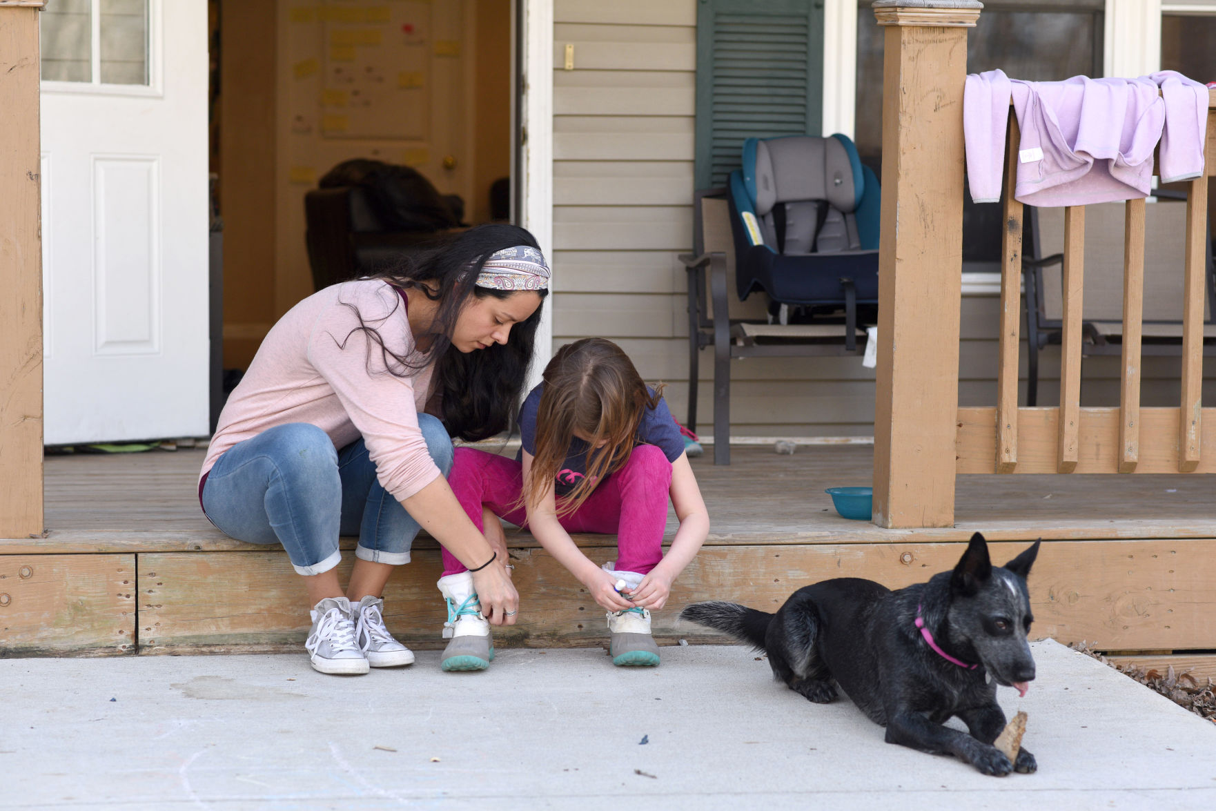 Violeta Douce helps a resident put her shoes